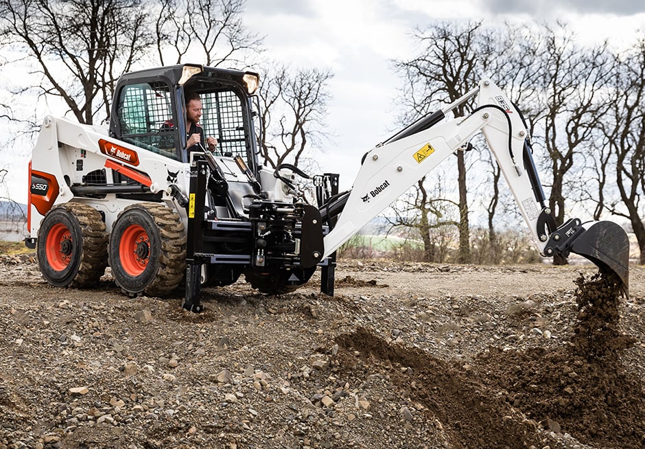 The new backhoe attachment converts a Bobcat loader into a powerful excavat...