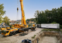 The Liebherr LTM 1400-6.1 lifting a 73-tonne precast basement element into an excavation pit in Oldenzaal, the Netherlands.