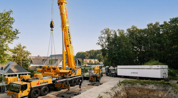 The Liebherr LTM 1400-6.1 lifting a 73-tonne precast basement element into an excavation pit in Oldenzaal, the Netherlands.