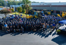 Employees gather with Komatsu wheel loaders at the Newberry Manufacturing Operation's 25th anniversary celebration, October 2, 2026
