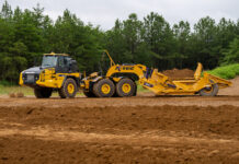 One Truck, Two Jobs: Komatsu Clears the K-Tec Scraper to Ride Behind Its HM460-6 The K-Tec 1237 ADT scraper towed by a Komatsu HM460-6 articulated dump truck