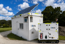 A United Rentals 20 ft solar platform and hybrid power unit supplying a site office
